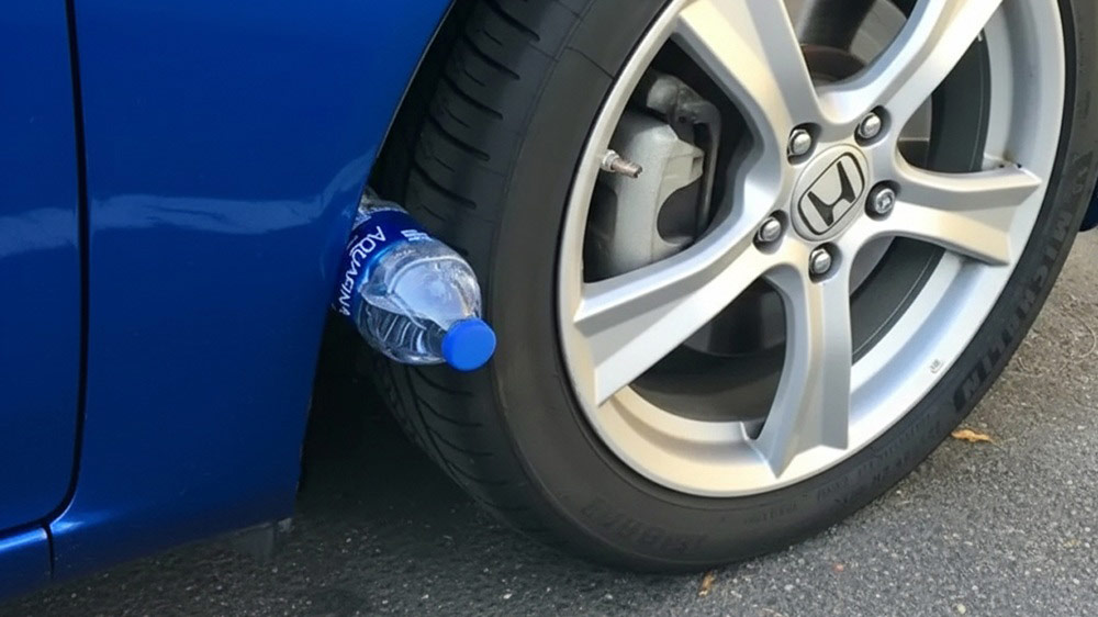 The Surprising Reason Drivers Place Water Bottles on Their Tires!